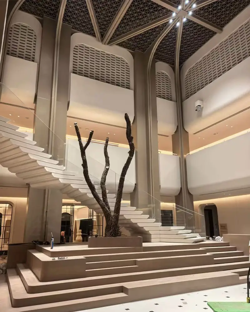 Custom steel frame trunk installation for a giant artificial tree in a luxury hotel lobby.